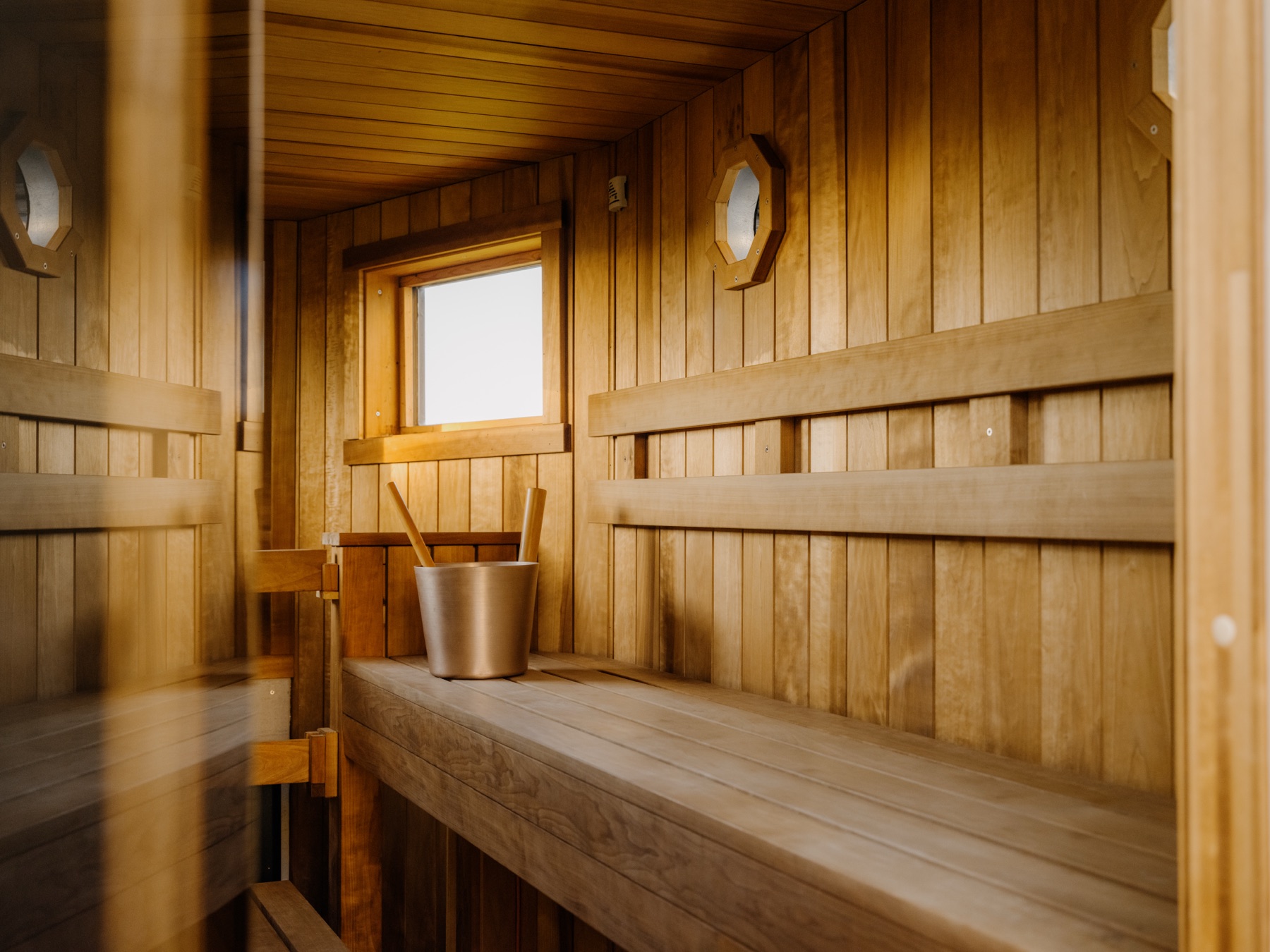 Inside the Fowey Hall sauna: heater, bucket and ladle
