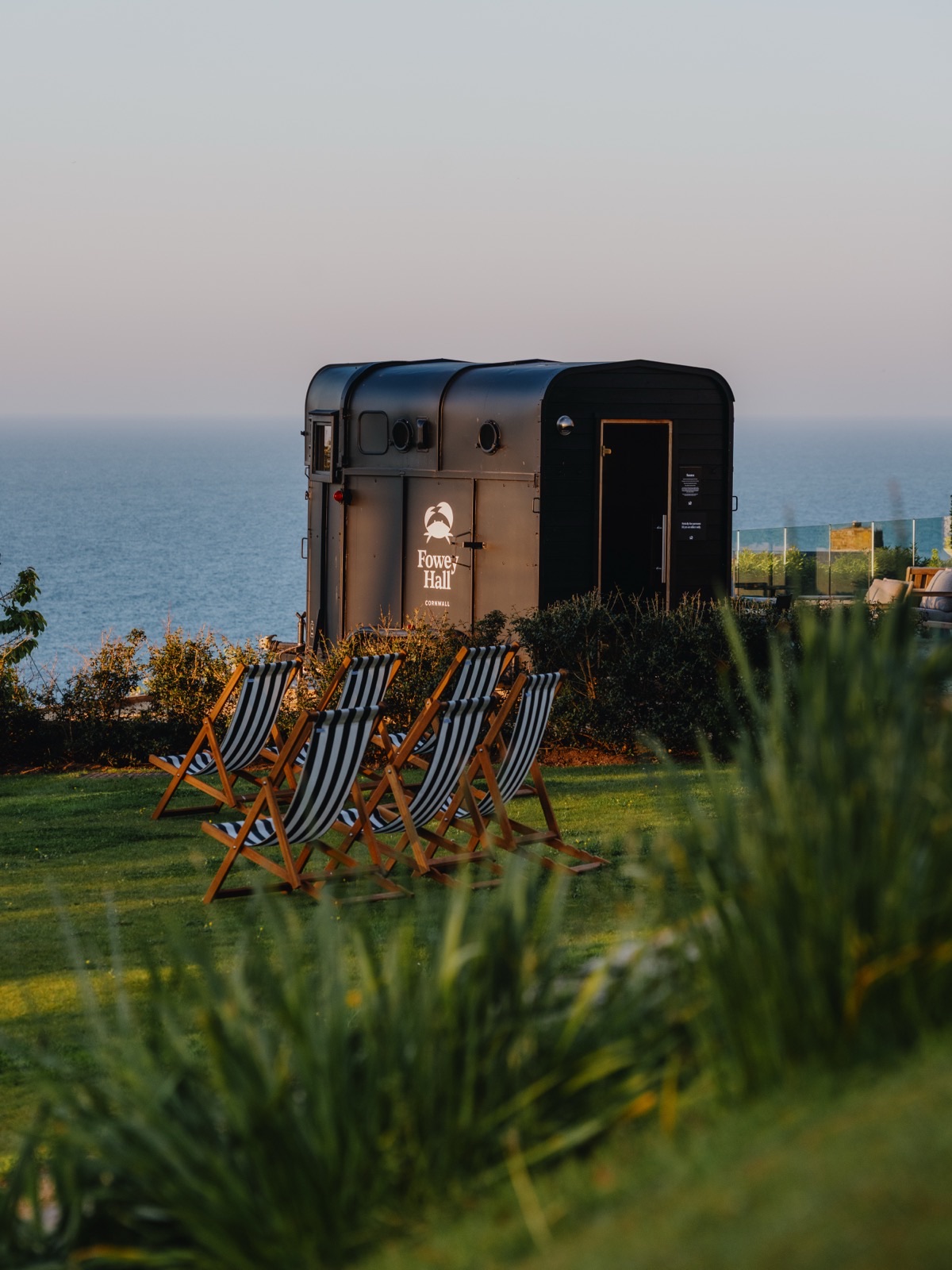 Deckchairs beside the Sauna Box horsebox installation at Fowey Hall Hotel