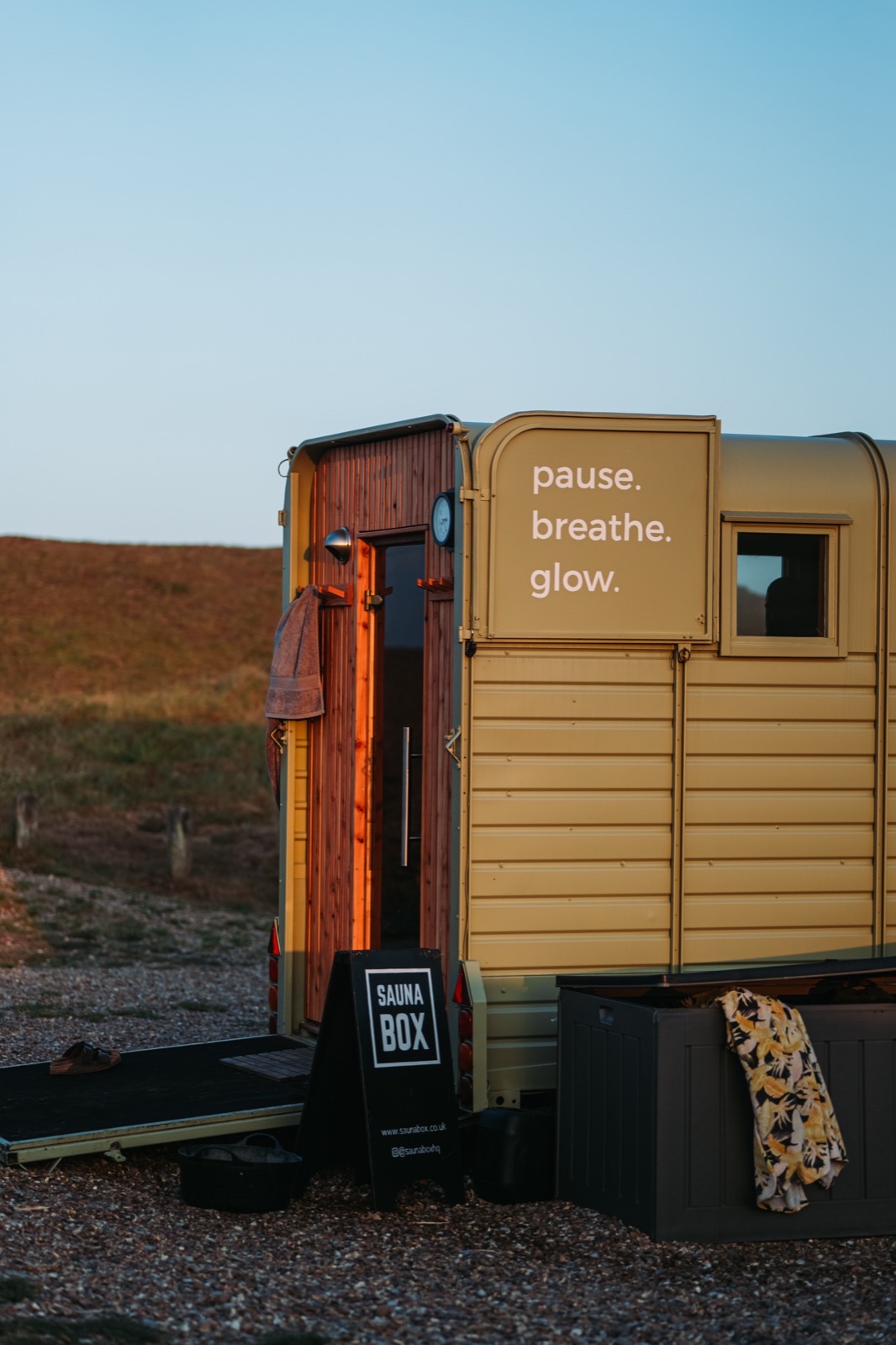 A person pausing to breathe beside a glowing sauna