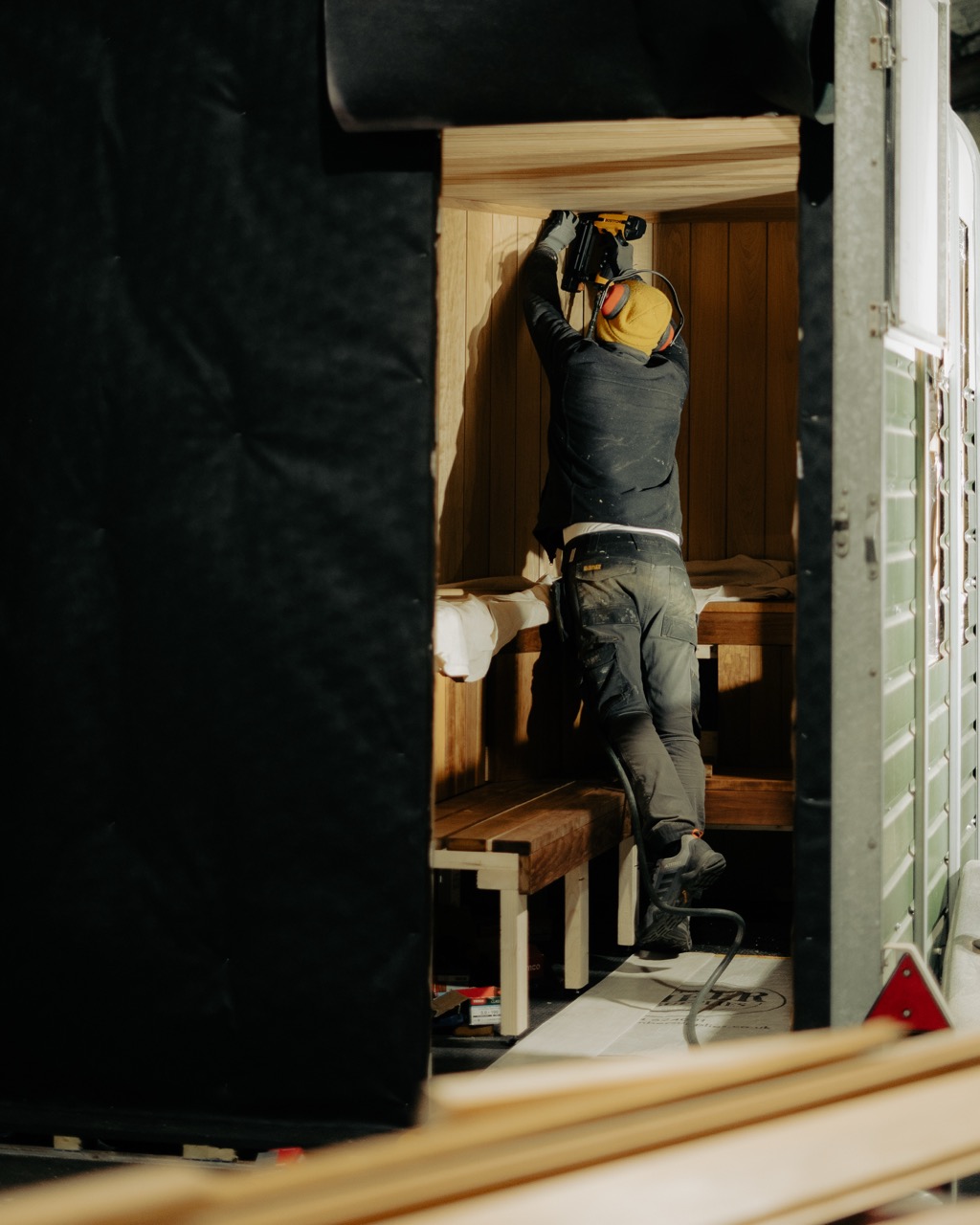 Builder fitting thermo aspen timber inside the horsebox under construction
