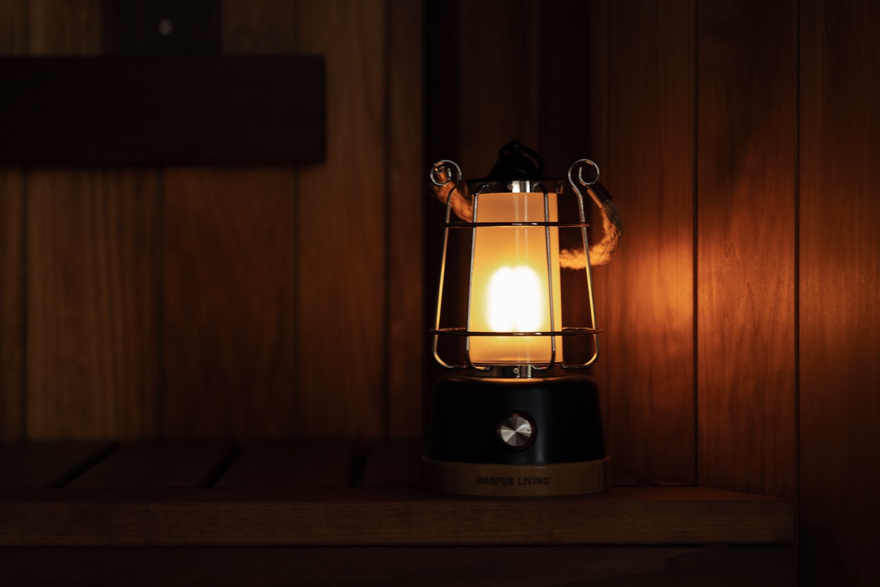 Lantern on sauna bench, warm atmospheric interior light