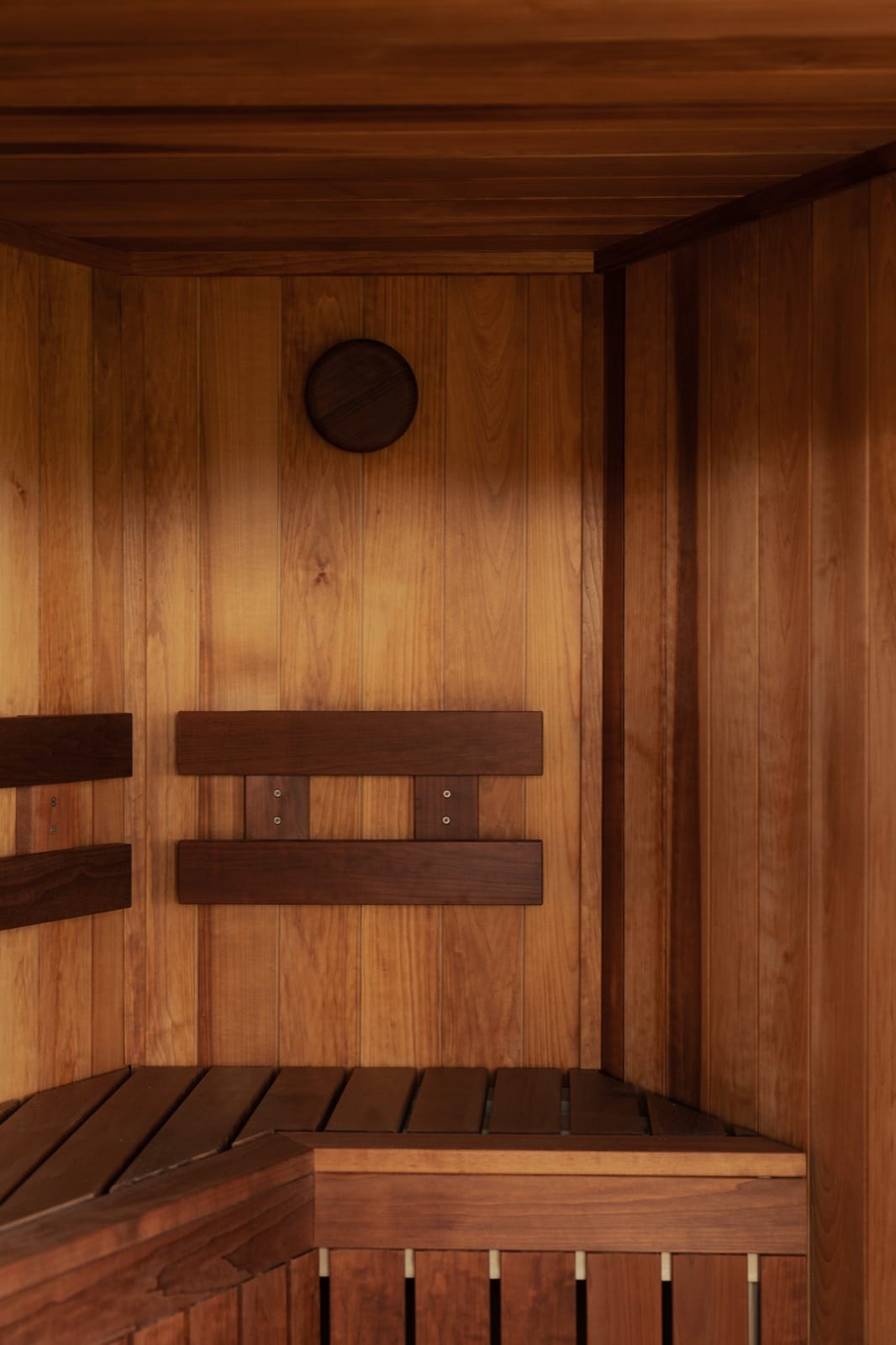 Detail of the tiered cedar benches and thermometer inside Island Sauna Shack's horsebox sauna