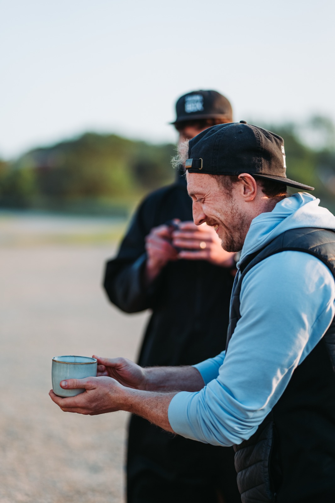A group of regulars laughing over morning coffee between sauna sessions