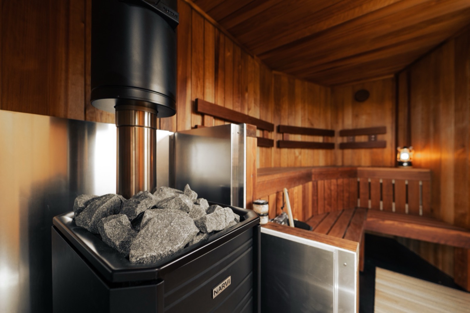 Interior of a handcrafted Sauna Box sauna with a traditional wood-fired heater