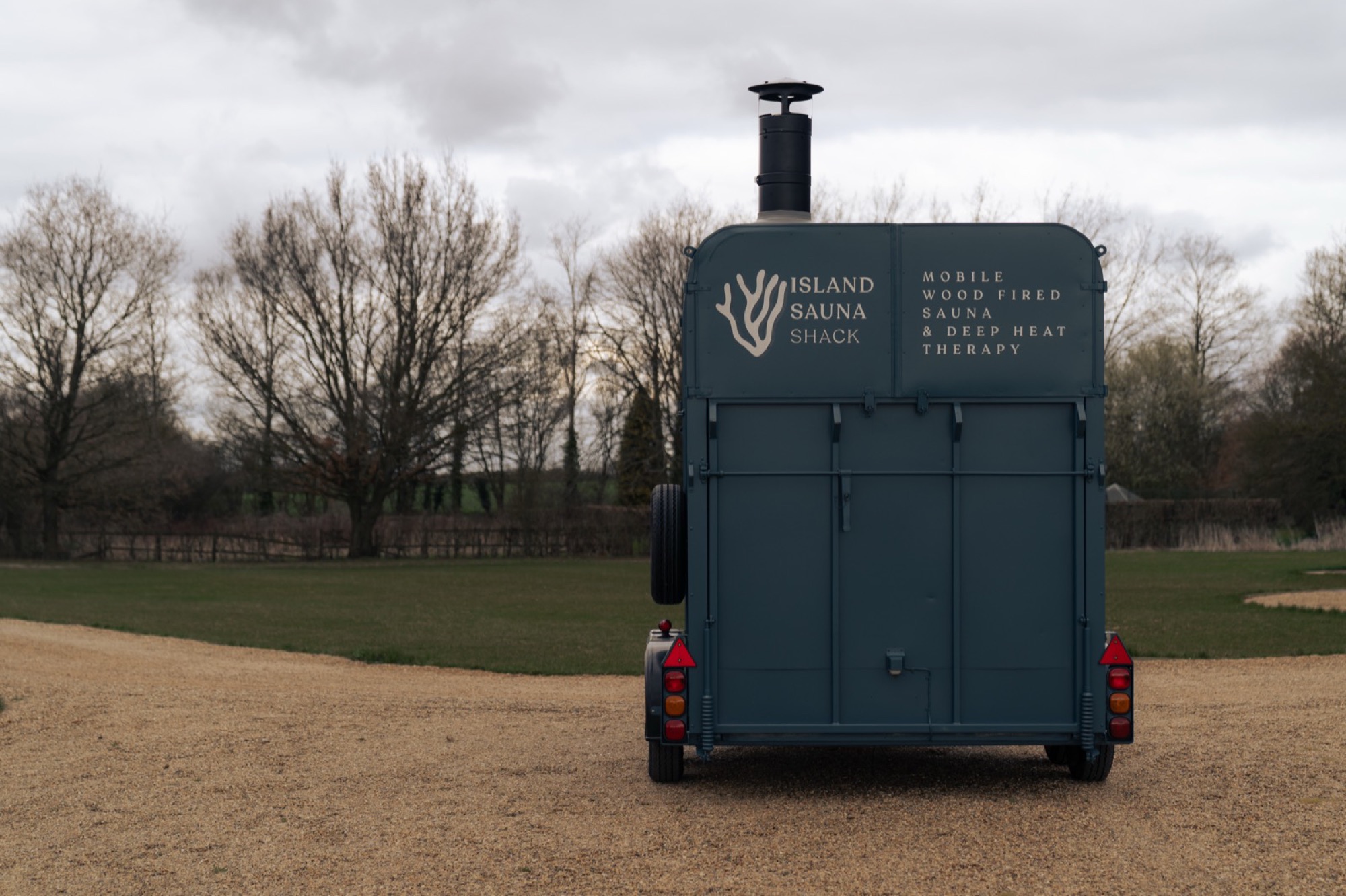 The Island Sauna Shack horsebox, mobile wood-fired sauna, in a manicured countryside setting on the Isle of Mull